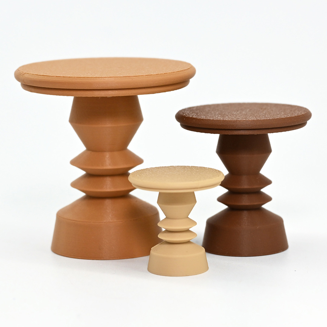 A trio of 3d printed accent table with geometric column bases