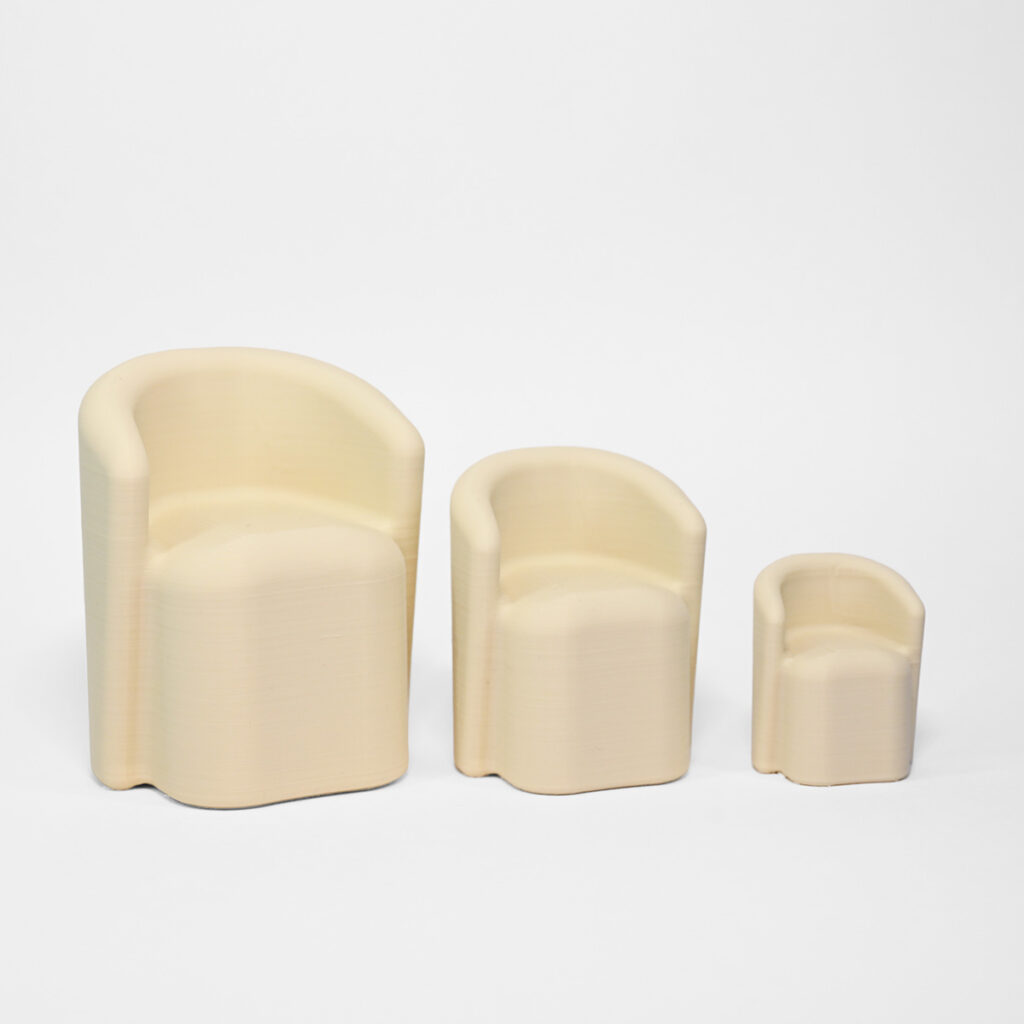 A set of three miniature 3d printed chairs