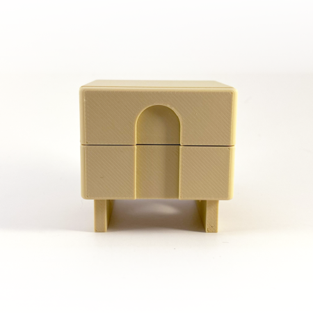 a tiny 3d printed nightstand with an arch detail in the drawers