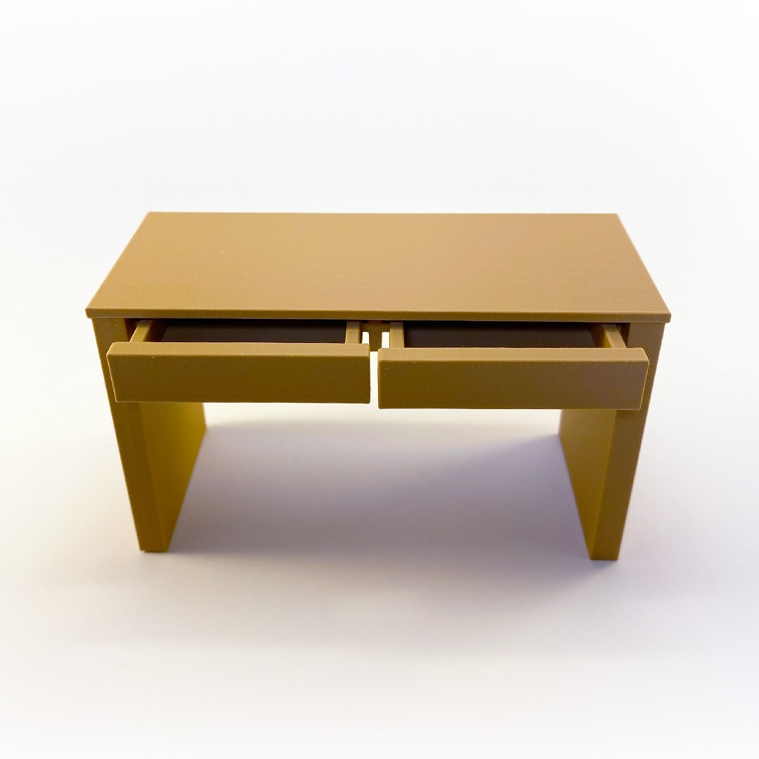 a photo of a miniature desk with the drawers open
